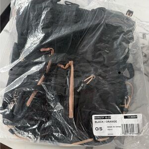 Unisex Black and Orange Lightweight Backpack great for runners or hikers.